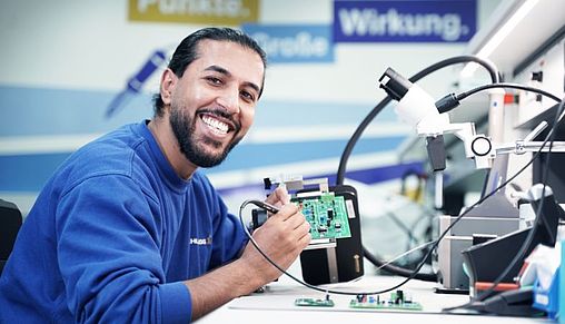 An industrial electrical engineering apprentice at work