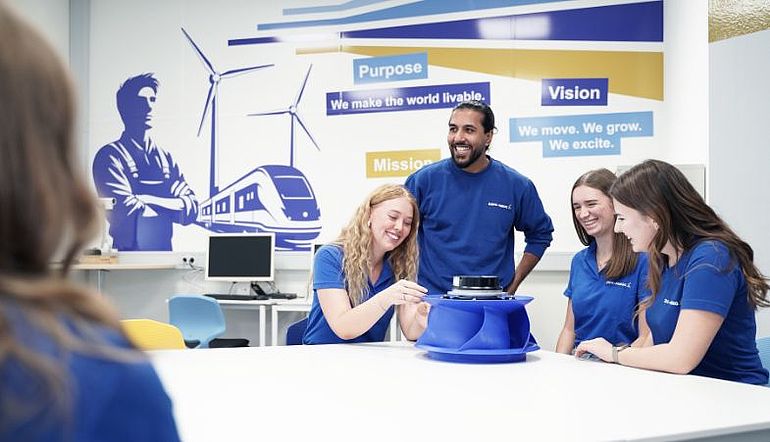 A group of apprentices with a centrifugal fan